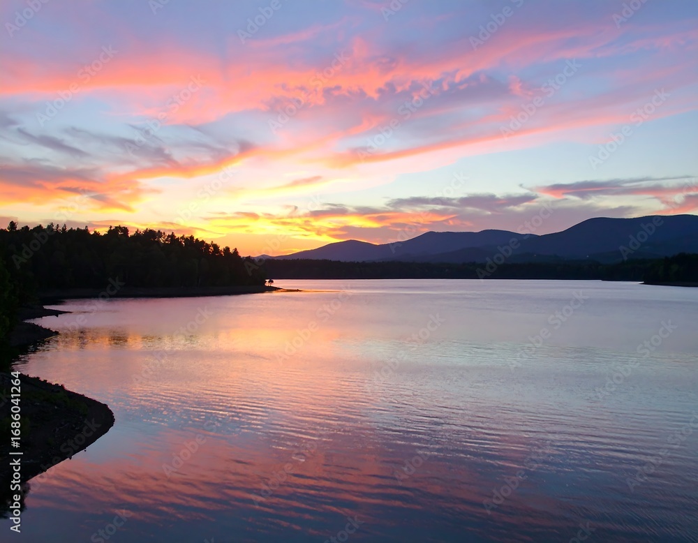 Fototapeta premium Serene sunset over a tranquil lake