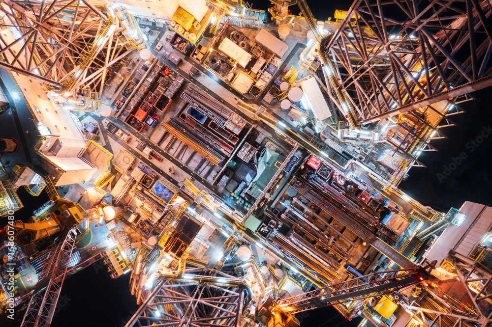 Obraz premium Aerial top view of offshore jack up rig and offshore platform during sunset for oil and gas exploration and production.