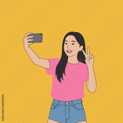 A person taking a selfie with a smartphone, smiling and making a peace sign against a yellow background.