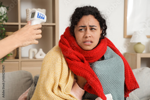 Girl with infrared thermome...