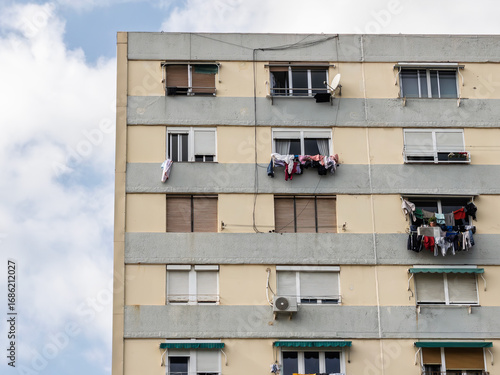 Canvas Print Laundry-draped balconies, closed shutters mark a mid-rise social housing block in Barcelona neighborhood illustrating affordable living conditions economic hardship, dense urbanism in Catalonia Spain