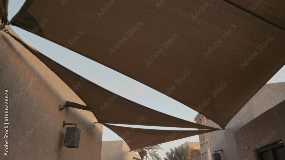 Fotografie Three triangular shade sails provide coverage in a calm residential courtyard