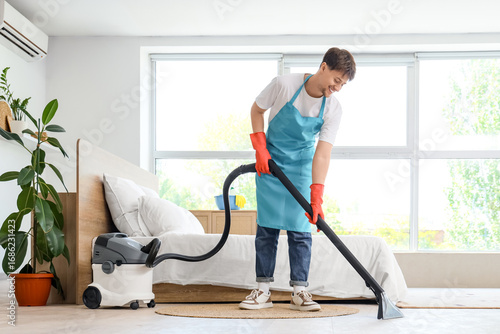 Young male janitor with mod...