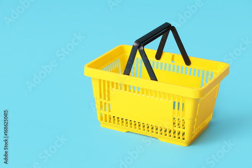 Yellow shopping basket on b...
