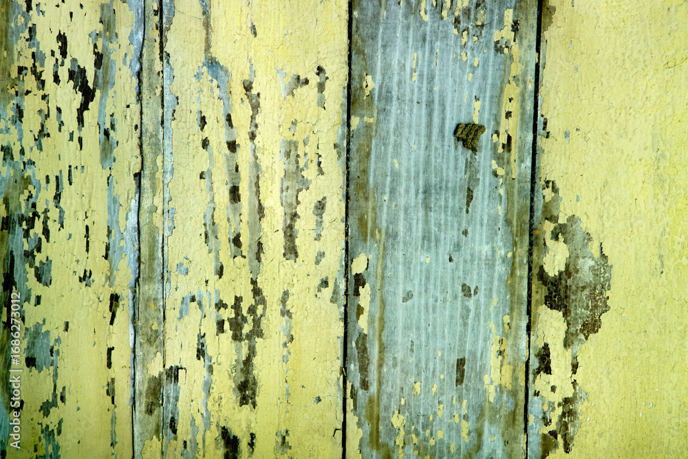 Obraz premium Aged Wood Planks with Peeling Yellow and Blue Paint in Distress