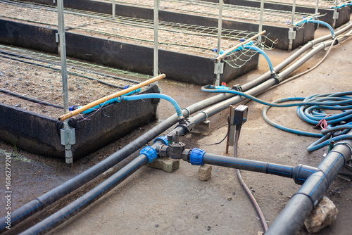 Close-up of an agricultural water management infrastructure system with pipes and valves. Modern agriculture. Maintenance of agricultural irrigation systems.