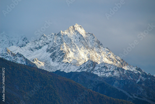 Jagged, snowy peaks loom under a cloudy sky
Yala Snow Mountain, Sichuan, China