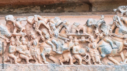 Pan: Detailed stone carving Halebeedu ancient temple Karnataka India showing warriors deities animals intricate sculptural art symbolizing heritage culture devotion
