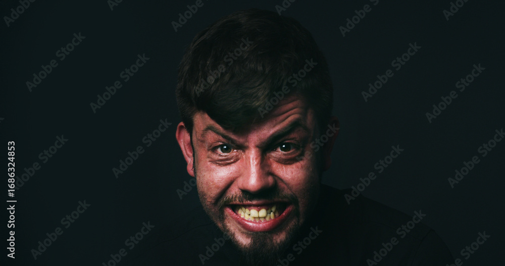 Fototapeta premium Anger, stress and portrait of man in studio for psychology, panic and schizophrenia symptoms. Fear, frustrated and mockup space with face of person with mental health on black background for rage