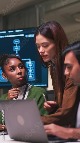 Teamwork and collaboration modern office as diverse professionals engage project discussion, planning business strategies with technology and laptop, focused meeting around digital screen workspace