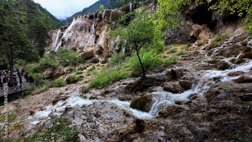 Jiuzhaigou, China: Panoramic footage of tourist who enjoy the view of the famous Pearl Shoals waterfall in Jiuzhaigou in the mountain of Sichuan in China