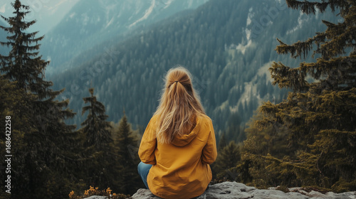 woman traveler looking at mountains and forest view