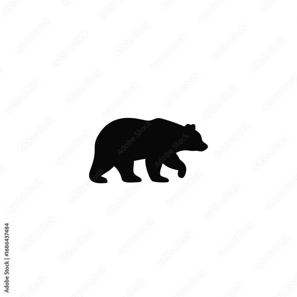 Fototapeta premium Black bear walking through grass with pine trees in the background