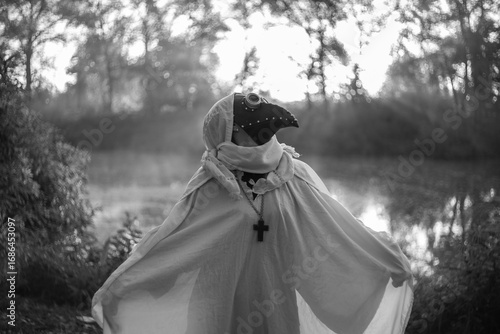 Foggy autumn landscape morning field with mysterious plague doctor