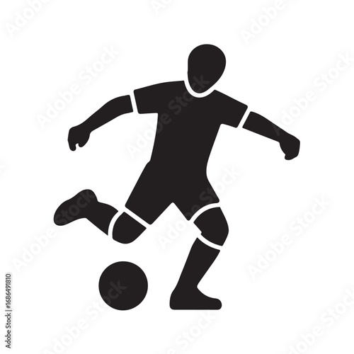 Silhouette of a soccer player kicking a ball
