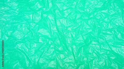 Wallpaper Mural Green crumpled plastic bag texture background rotating. Real High-Density Polyethylene shopping bag. HDPE shopper texture. Torontodigital.ca