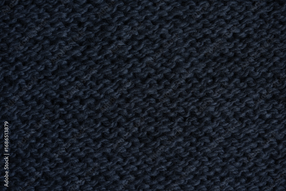 Fototapeta premium gray texture of knitted wool fabric as a background, grey smooth symmetrical lines of hand-knitted needlework pattern 