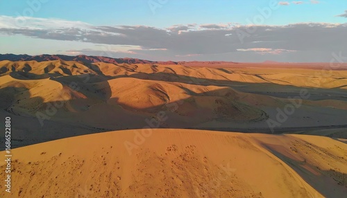 Fototapeta Naklejka Na Ścianę i Meble -  Aerial View of Beige Sand Dunes at Sunset