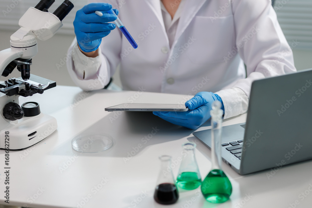 Fototapeta premium Scientist observing chemical reaction in glassware.
