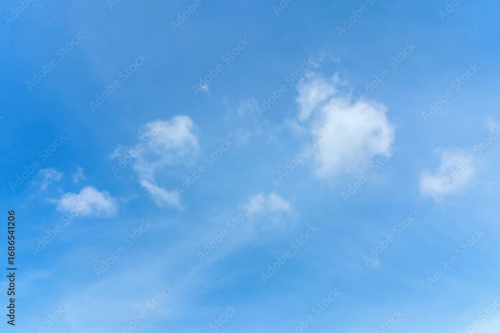 Fototapeta premium the sky is clear and bright and the clouds are scattered throughout the sky. blue sky with white clouds.