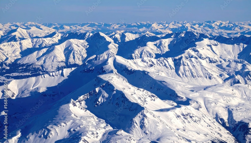 Fototapeta premium Aerial View of Snowy Mountain Ridges and Alpine Contours