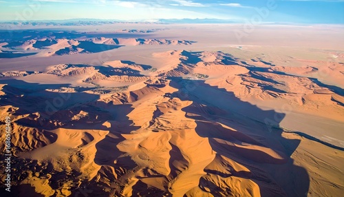 Aerial View of Warm Beige Sand Dunes and Rock Formations