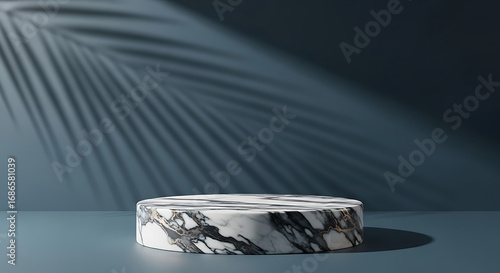 Minimalist marble podium with palm leaf shadow on blue background for product display
