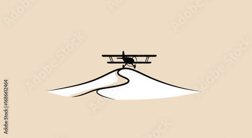 Vintage biplane silhouette resting on a desert sand dune.