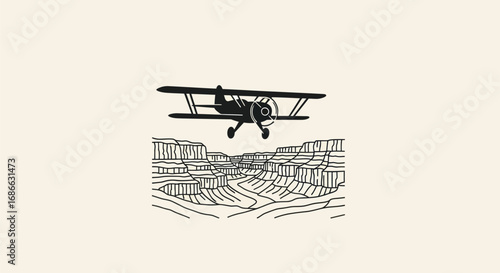 Vintage biplane soaring high above a dramatic canyon.
