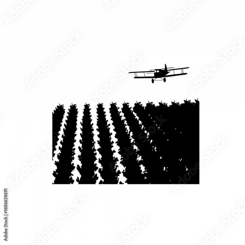 Silhouette of farmland with crop duster spraying herbicide over weed patches