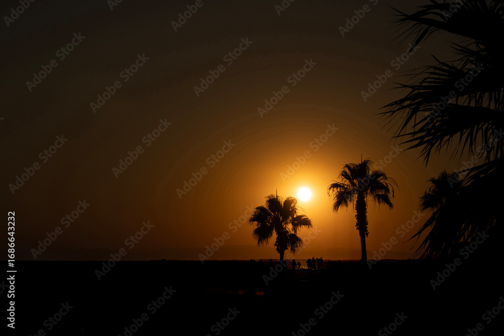 Obraz premium Silhouettes of People Enjoying a Sunset by the Sea Side, Antalya