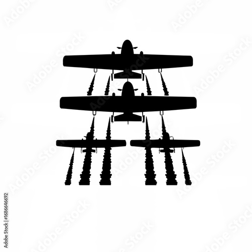 Silhouette of crop duster spraying chemicals with visible trails