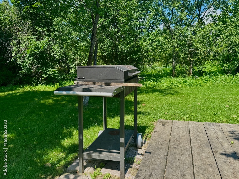 Naklejka premium barbecue area on the territory of a country house on a summer day. High quality photo