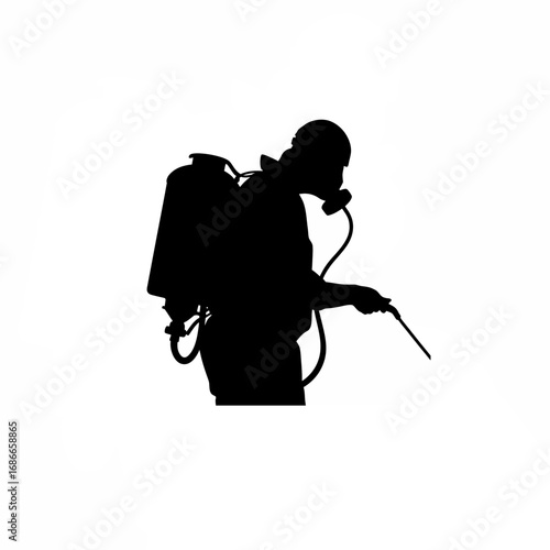 Silhouette of pilot in safety mask spraying herbicide