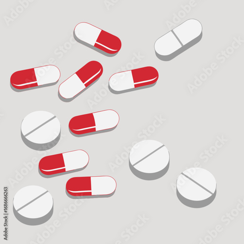 Medical concept with a variety of scattered red and white pills and tablets