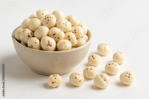 High quality photo realistic image of healthy puffed lotus seeds makhana in bowl isolated on clean white background for commercial use