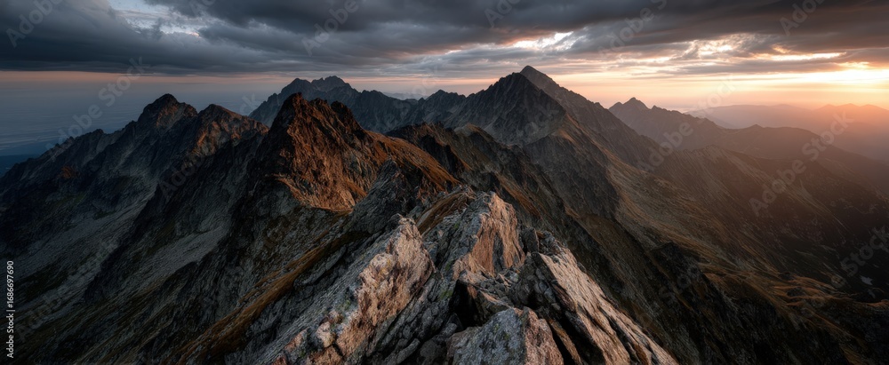 Fototapeta premium A rocky mountain with a cloudy sky in the background