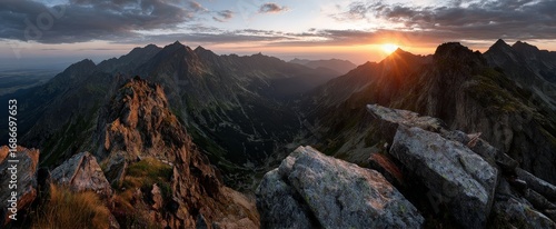 A rocky mountain with a cloudy sky in the background