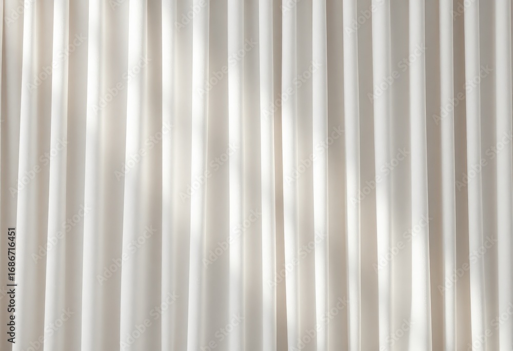 Obraz premium Soft, sheer curtains diffuse sunlight, casting delicate shadows on a neutral wall.