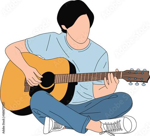 Young person sitting cross legged playing an acoustic guitar with a relaxed expression