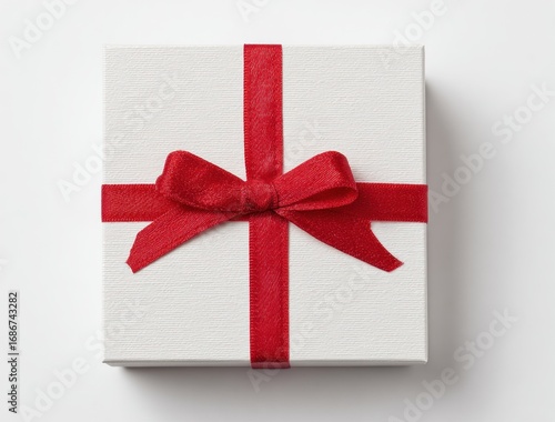 A textured, white gift box tightly bound with a red satin ribbon and bow, sitting on a plain, light background, casting a soft shadow
