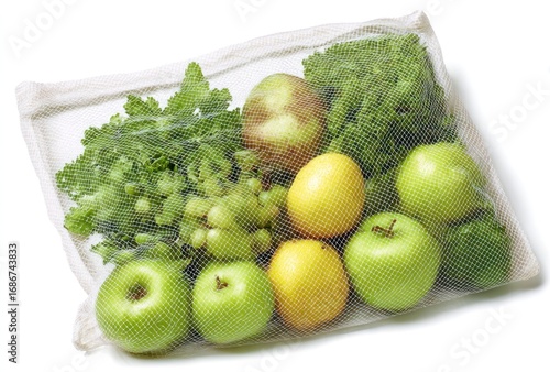 An assortment of fresh fruits and leafy greens inside a reusable mesh bag, casting soft shadows on a white surface