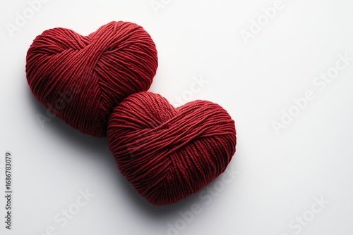Heart-shaped Red Yarn Balls on a White Surface for Crafting and Decoration Pr...
