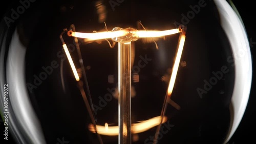 Illuminated Filament Closeup of a classic incandescent light bulb with idea concept.