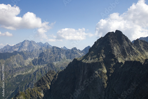 Mountain landscape. European mountains Tatras mountains. Mountains tops in the clouds, blue sky. The Tatra Mountains. The tops of the mountain peaks.