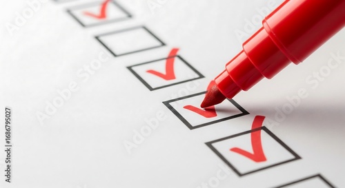 Red marker checking boxes on a checklist.