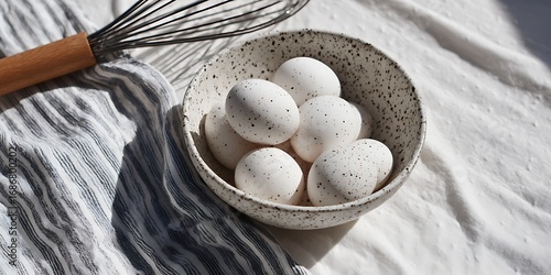 Farm fresh eggs in a speckled bowl with a whisk