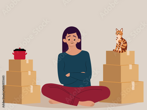 Young woman sitting on the floor surrounded with cardboard boxes. Moving house concept