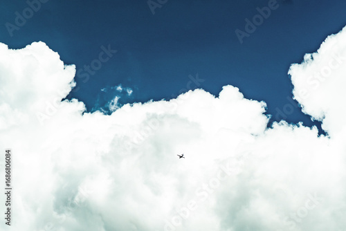 blue sky and clouds and a plane