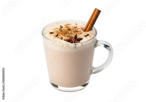 A glass mug of spiced tea latte, topped with frothy milk, cinnamon sticks, and star anise, is presented against a black background.